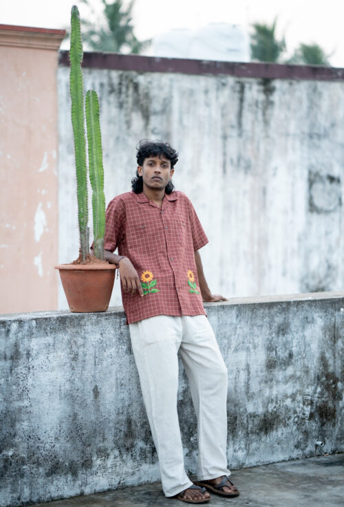 Cross stitch embroidered sunflower shirt.